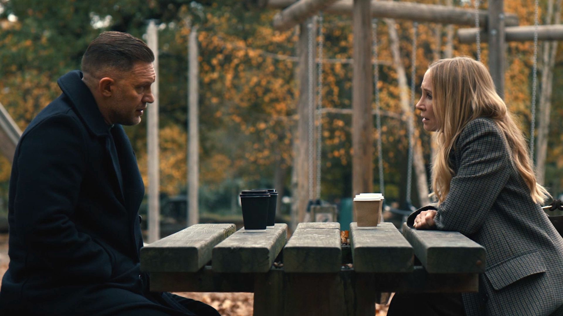 Jan and Harry sit at an outdoor picnic bench