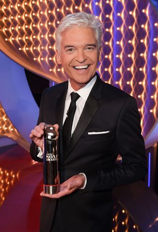 Phillip Schofield holding an award at The British Soap Awards
