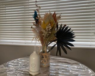 ESPA Essential Oil Diffuser on marble table beside dried flowers