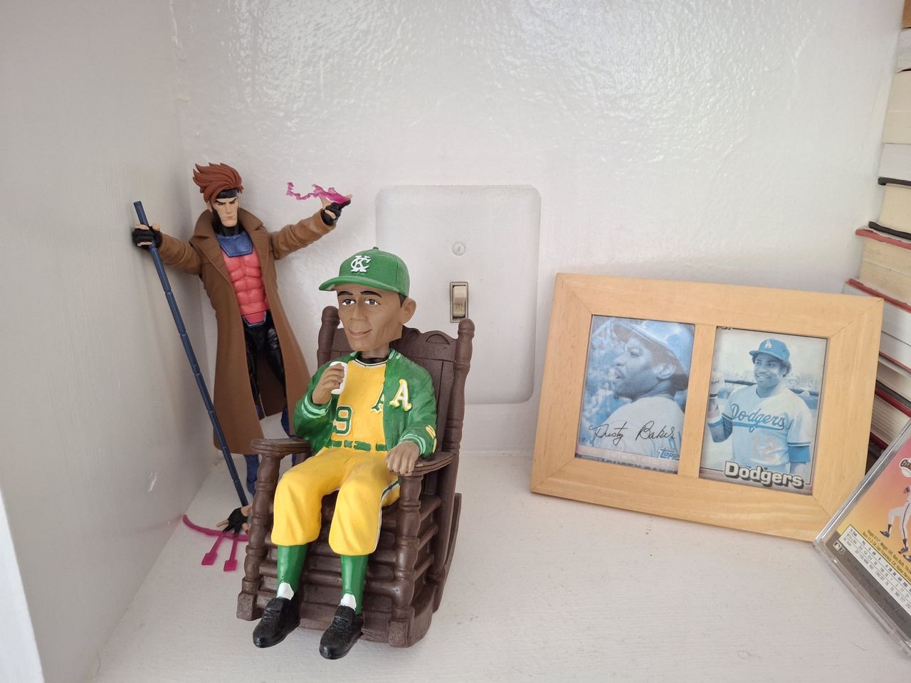 shot of gambit figurine behind Satchel Paige bobblehead shot by galaxy a35
