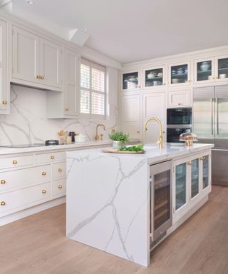 White marble kitchen island with cabinets and white cooler