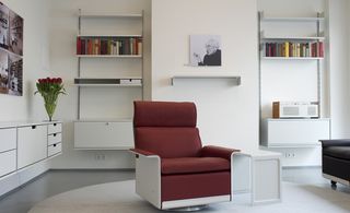 A lounge chair with book shelves at the back