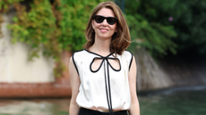 Sofia Coppola wearing a white top and black trousers