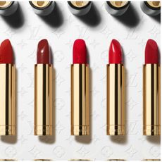 five gold lipstick tubes