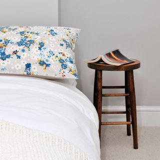 bedroom with bedside stool table and book
