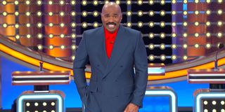 Steve Harvey laughing at a category on Family Feud