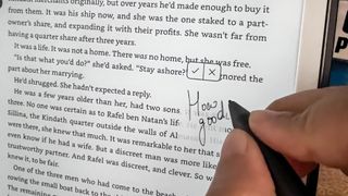 A person writing in the margin of an ebook on the Amazon Kindle Scribe (2024)