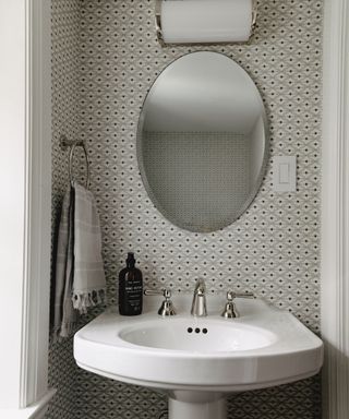 Small design black and white wallpaper, chrome fixtures and fittings