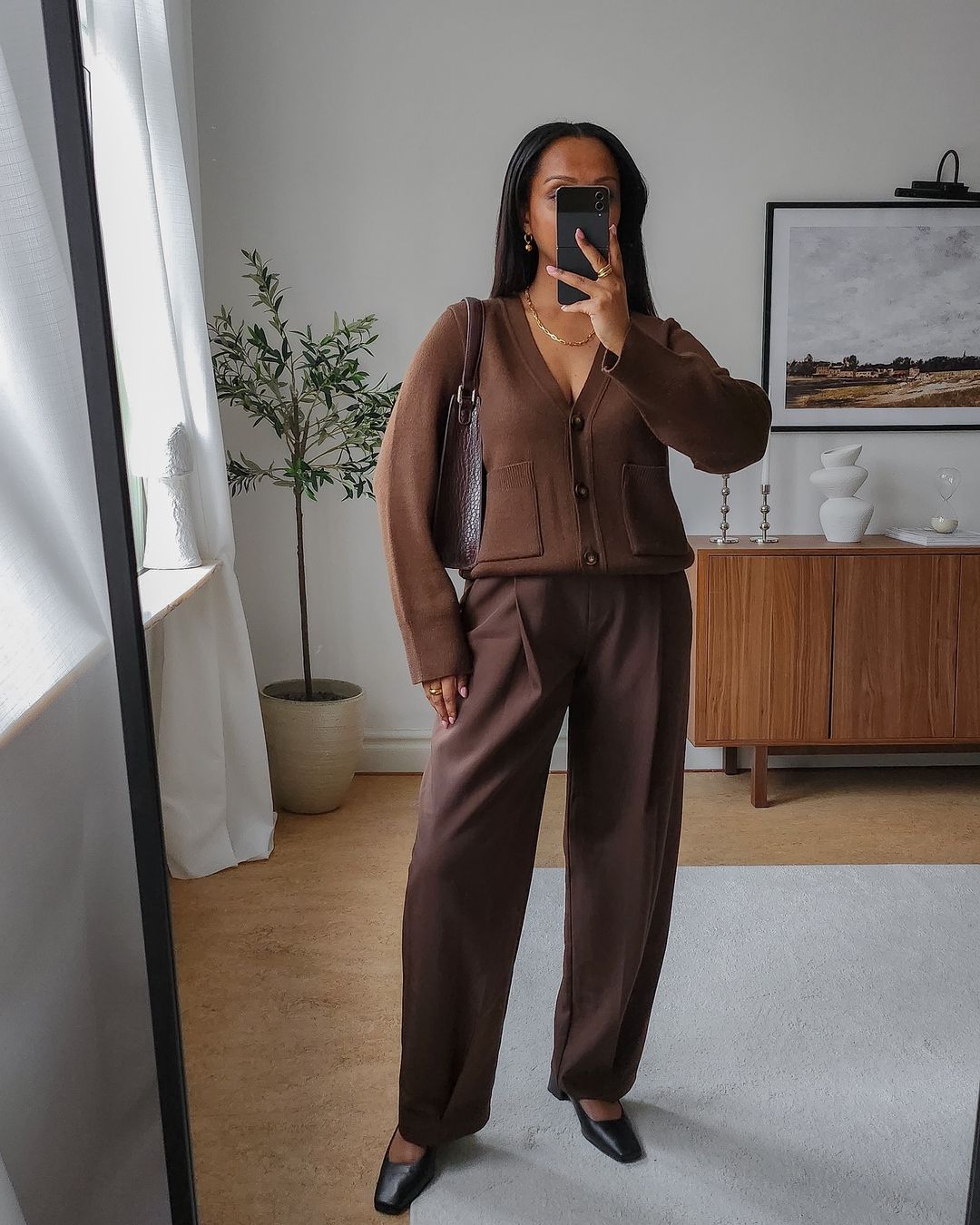 @femmeblk wearing brown trousers and cardigan with flats