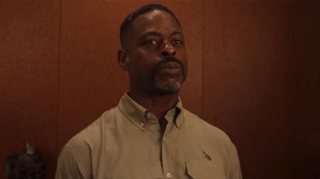 Sterling K. Brown looking stoic in a khaki button down in Is God Is