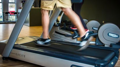 How to buy a treadmill: person runnin on a treadmill at home