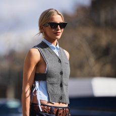 woman with blonde hair, sunglasses and vest in sunshine - best spf for body