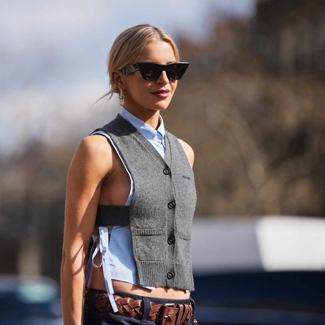 woman with blonde hair, sunglasses and vest in sunshine - best spf for body