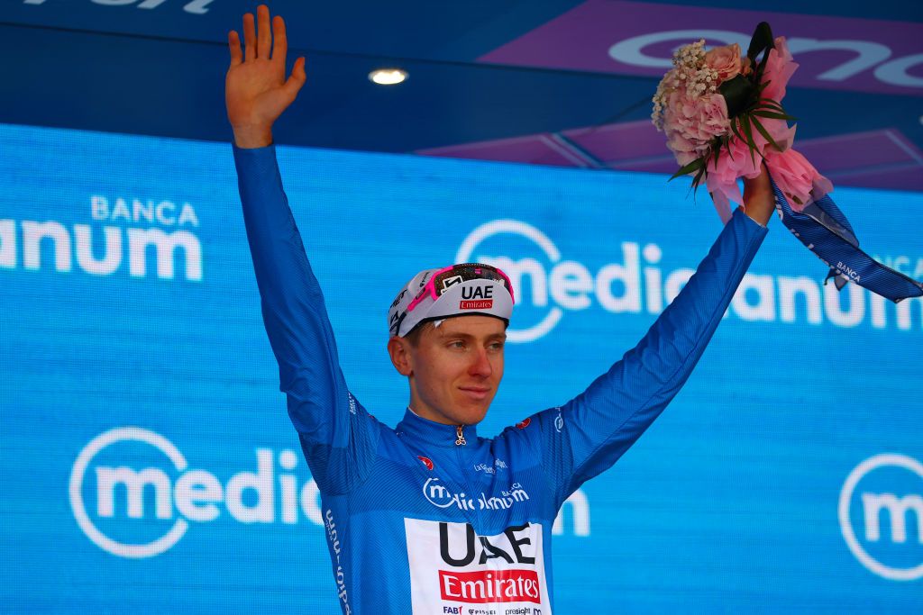 Team UAE's Slovenian rider Tadej Pogacar celebrates the best climber's blue jersey on the podium of the 12th stage of the 107th Giro d'Italia cycling race, 193km between Martinsicuro and Fano, on May 16, 2024. (Photo by Luca Bettini / AFP)