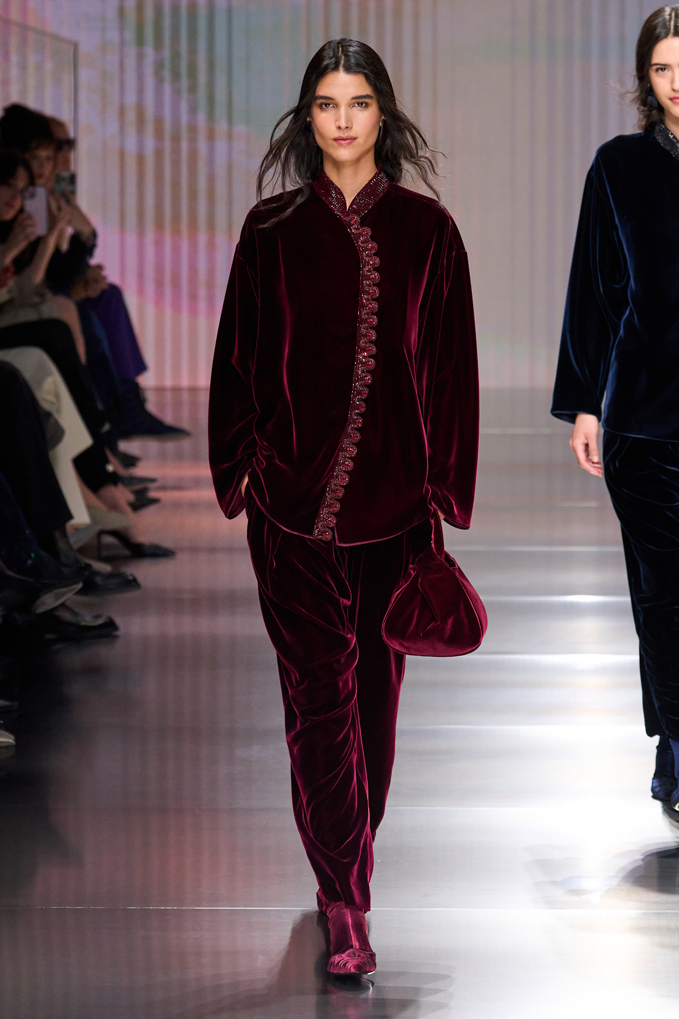 a woman walks the giorgio armani fall/winter 2026 show.