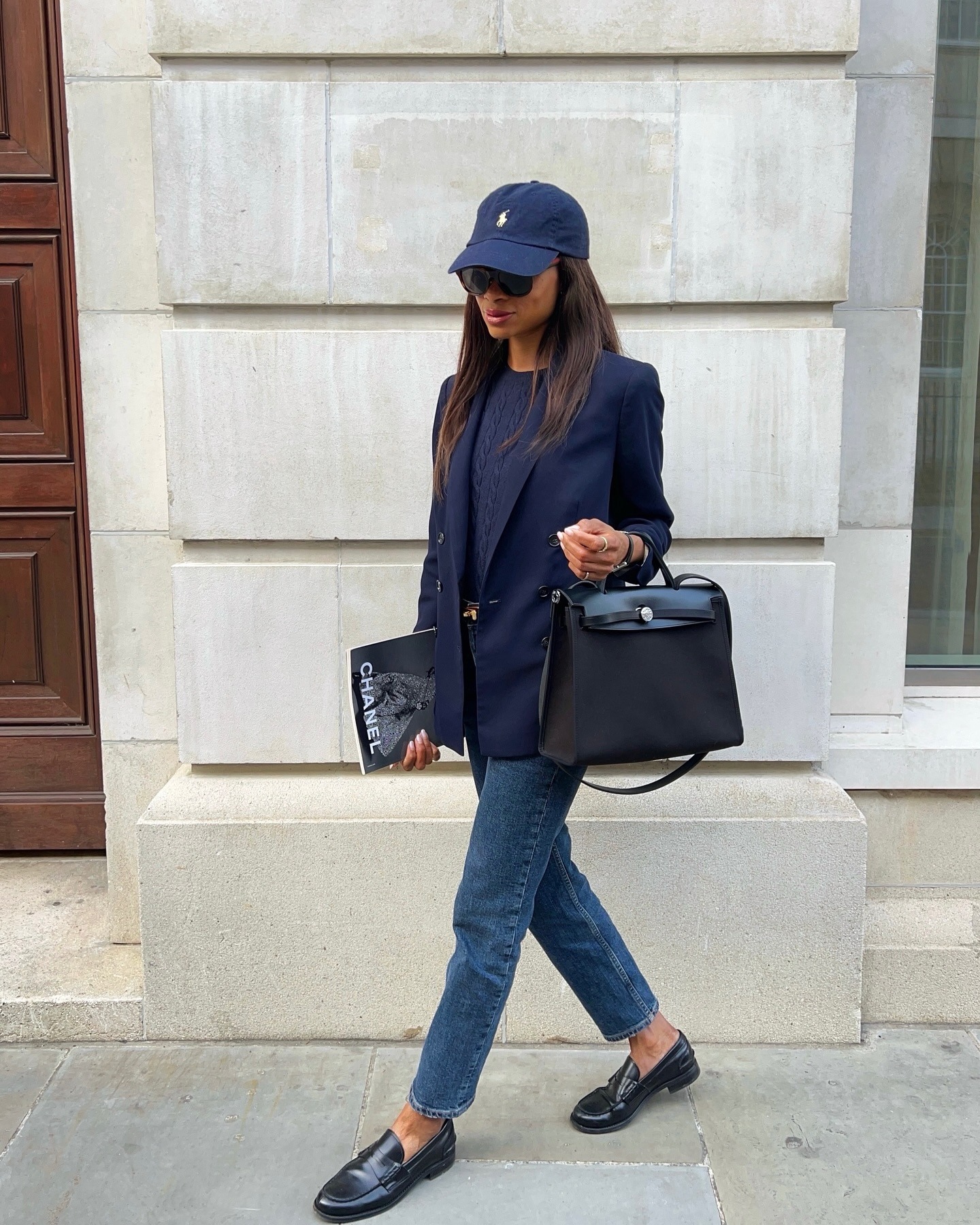 Woman in jeans, blazer, and black loafers