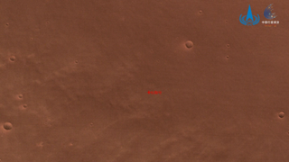 The red surface of Mars dotted by craters