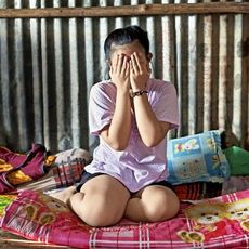 cambodian girl covering her face