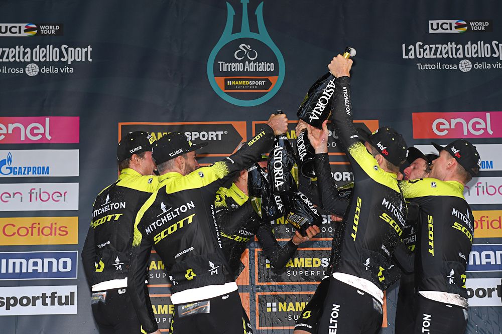 Mitchelton-Scott riders celebrate the team time trial win on the Tirreno-Adriatico podium