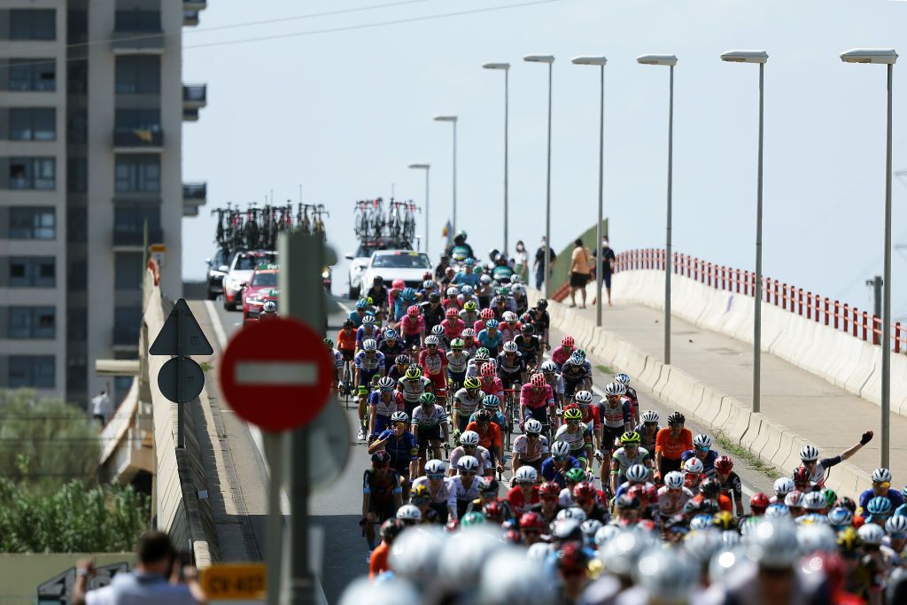 ALTO DE LA MONTAA DE CULLERA SPAIN AUGUST 19 A general view of the Peloton passing through Valencia City during the 76th Tour of Spain 2021 Stage 6 a 1583km stage from Requena to Alto de la Montaa de Cullera 184m lavuelta LaVuelta21 on August 19 2021 in Alto de la Montaa de Cullera Spain Photo by Gonzalo Arroyo MorenoGetty Images