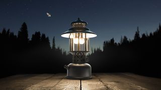A lantern on a camping table at night