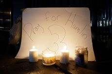 "Pray for Hamlin" sign behind candles.