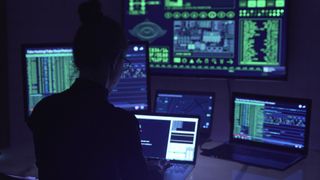 Security analyst working with multiple screens in front of them