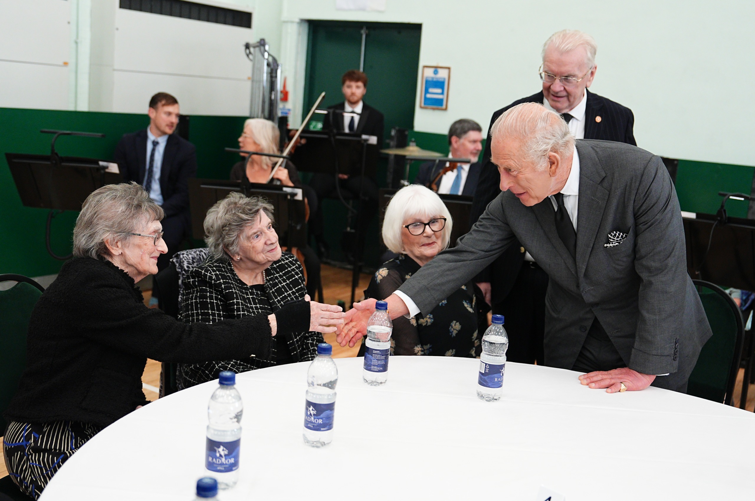 King Charles shakes hands with members of the Aberfan Wives Group.