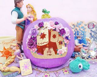 Pumpkin carving ideas using purple paint and gold glitter cards with Disney's Tangled themed accessories