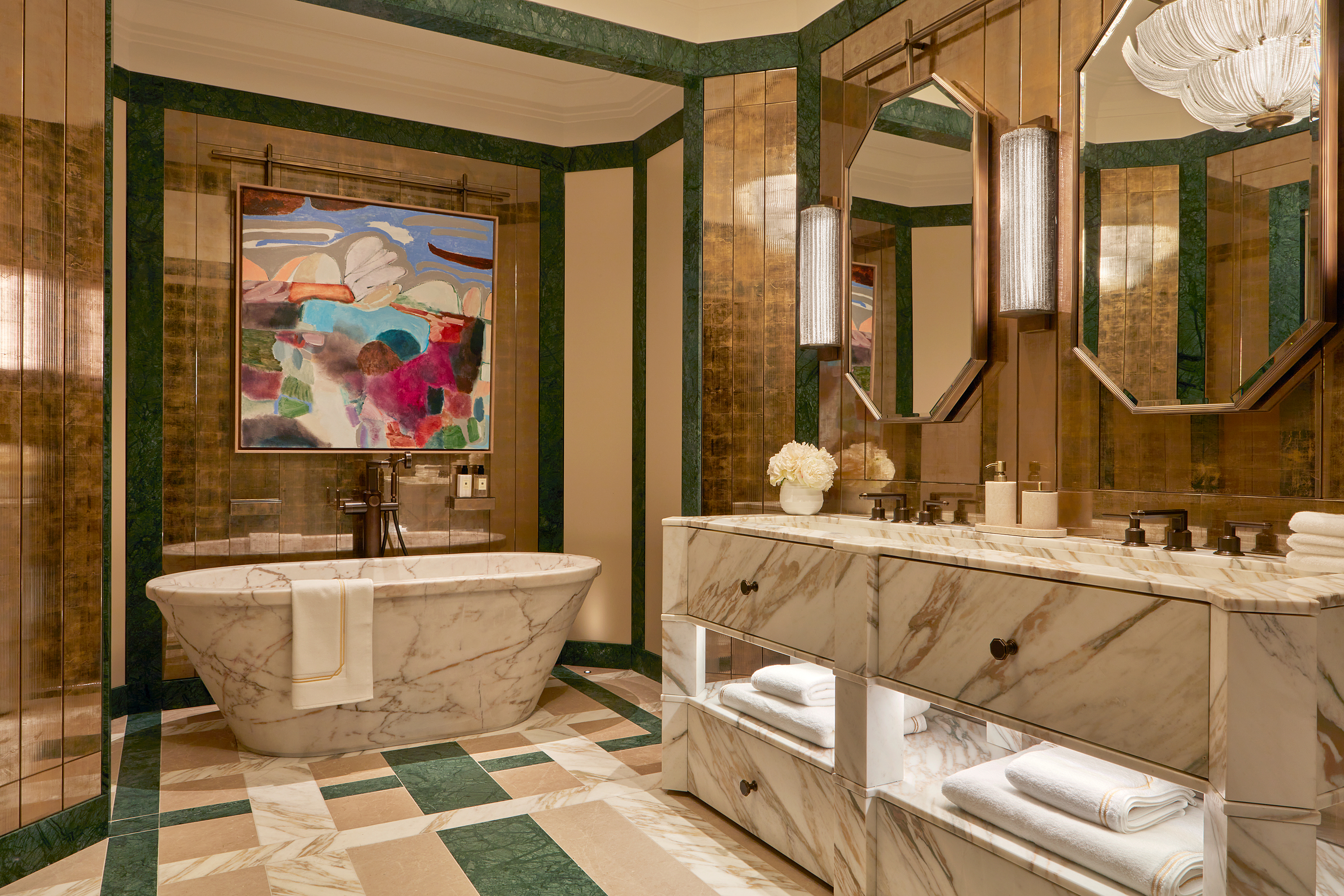 an art deco bathroom in white, cream and green marble with art deco shaped motifs