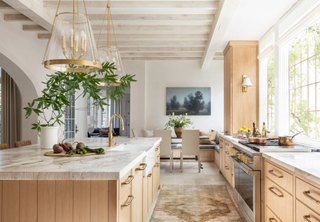 Oak kitchen with marble countertop and seating