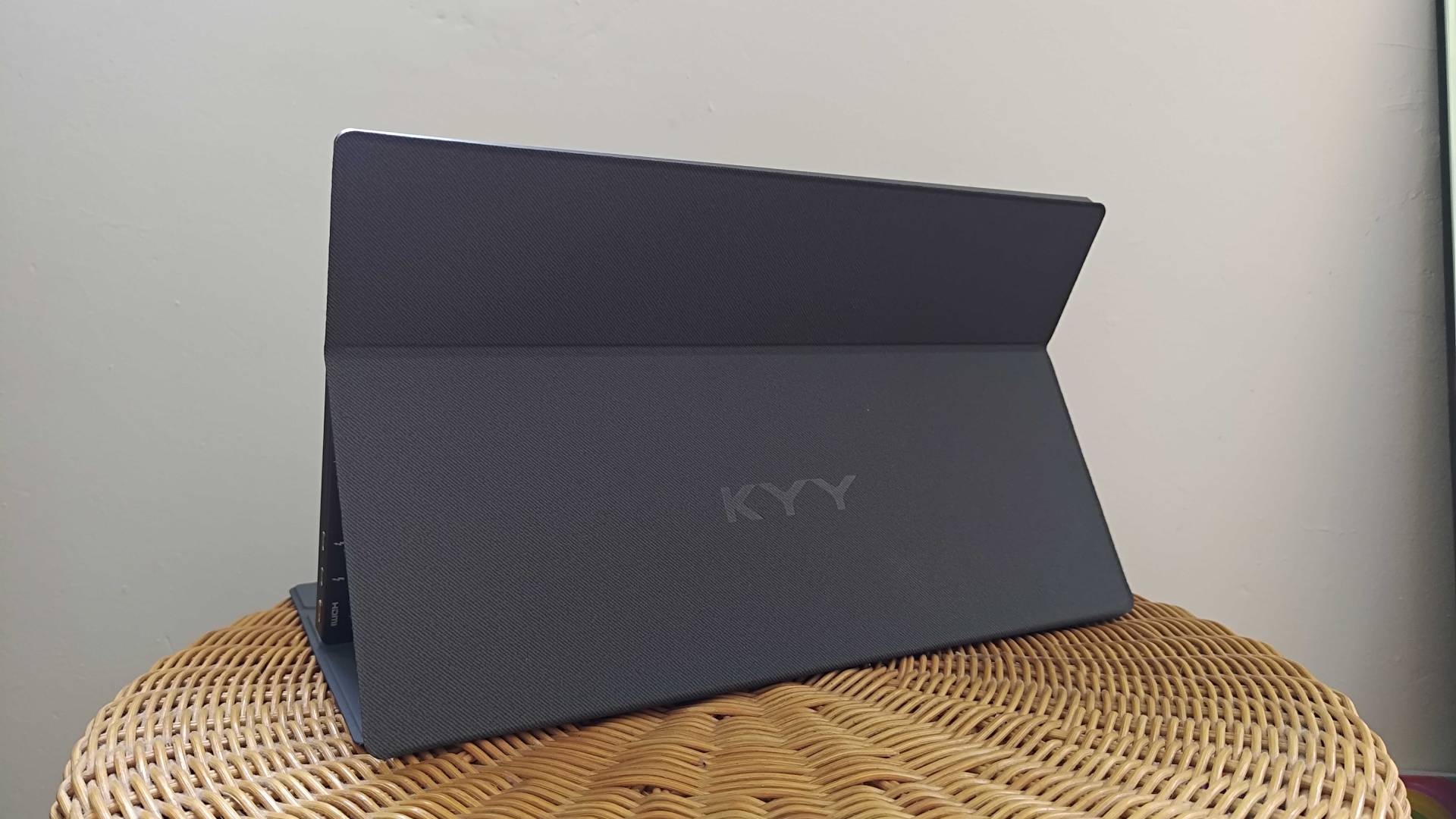 KYY Portable Monitor on wicker tilted to side with back stand in view