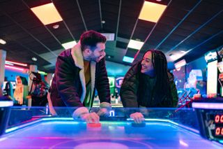 couple on a date at an arcade playing an arcade game