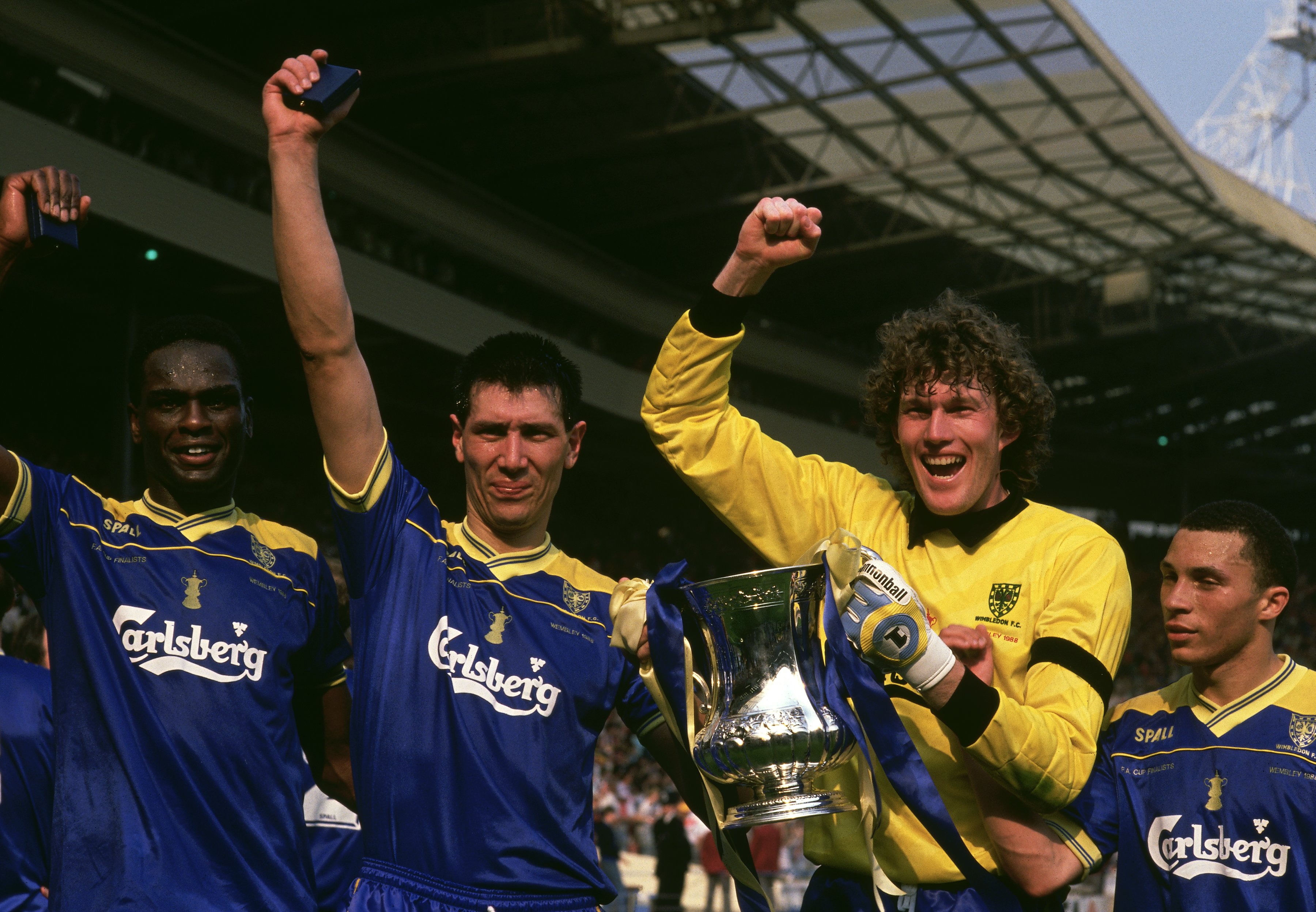Eric Young, Lawrie Sanchez, Dave Beasant and Terry Phelan celebrate Wimbledon's FA Cup win in 1988 after victory against Liverpool at Wembley.
