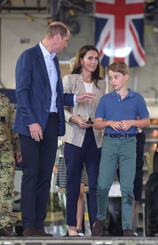 Kate Middleton braves the rain in chic pinstripe blazer