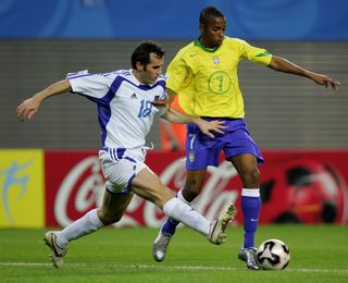 Greece's Giannis Goumas (left) competes for the ball with Brazil's Robinho at the 2005 Confederations Cup.