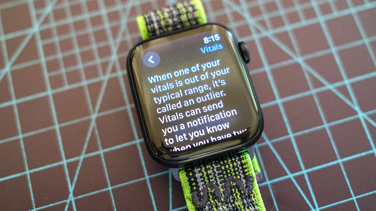 The Apple Watch SE on a green and grey cloth strap showing details from the new Vitals app