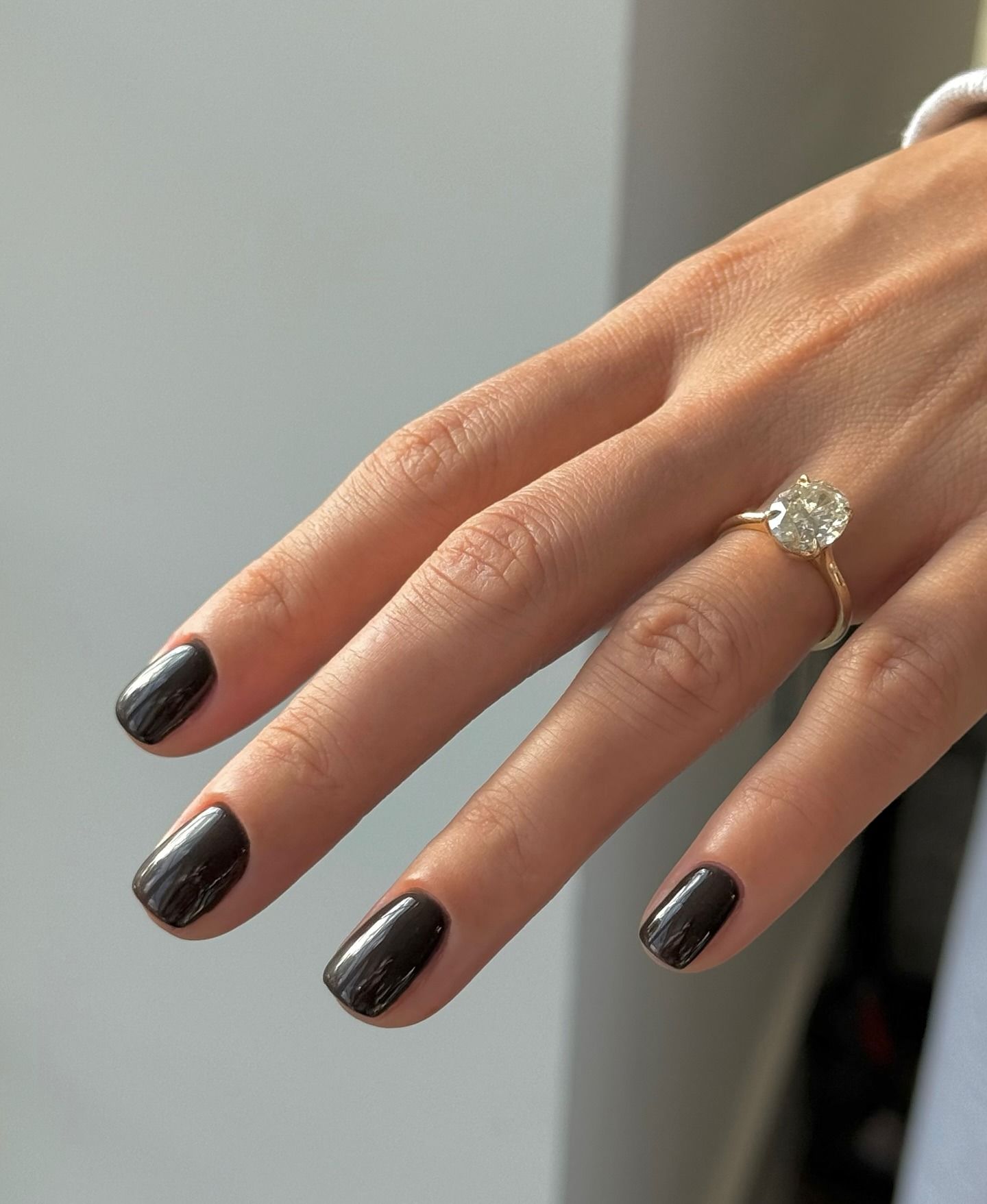 A picture of a short, glossy, black manicure