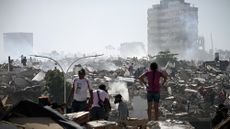 Volunteers in Venezuela search for possible victims in a collapsed building following twin earthquakes in Caraballeda, La Guaira state, some 40 km northeast of Caracas.