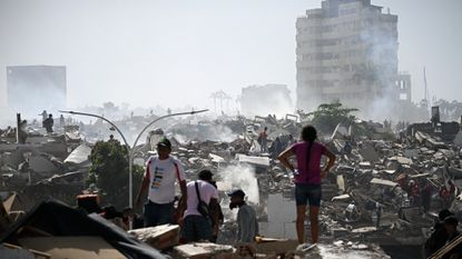 Volunteers in Venezuela search for possible victims in a collapsed building following twin earthquakes in Caraballeda, La Guaira state, some 40 km northeast of Caracas.