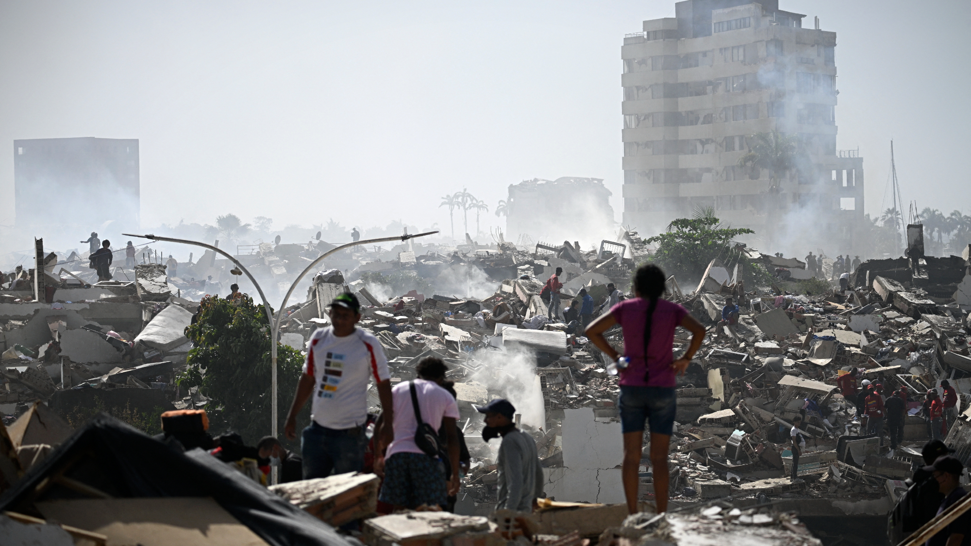 Volunteers in Venezuela search for possible victims in a collapsed building following twin earthquakes in Caraballeda, La Guaira state, some 40 km northeast of Caracas.