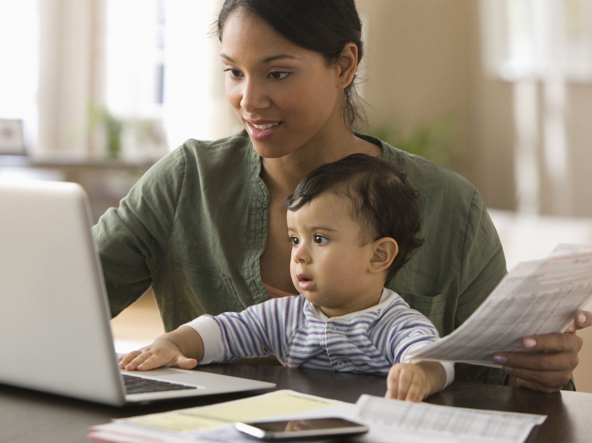 My mother is working. Electronic Family Lifestyle. Mother working with her boy.