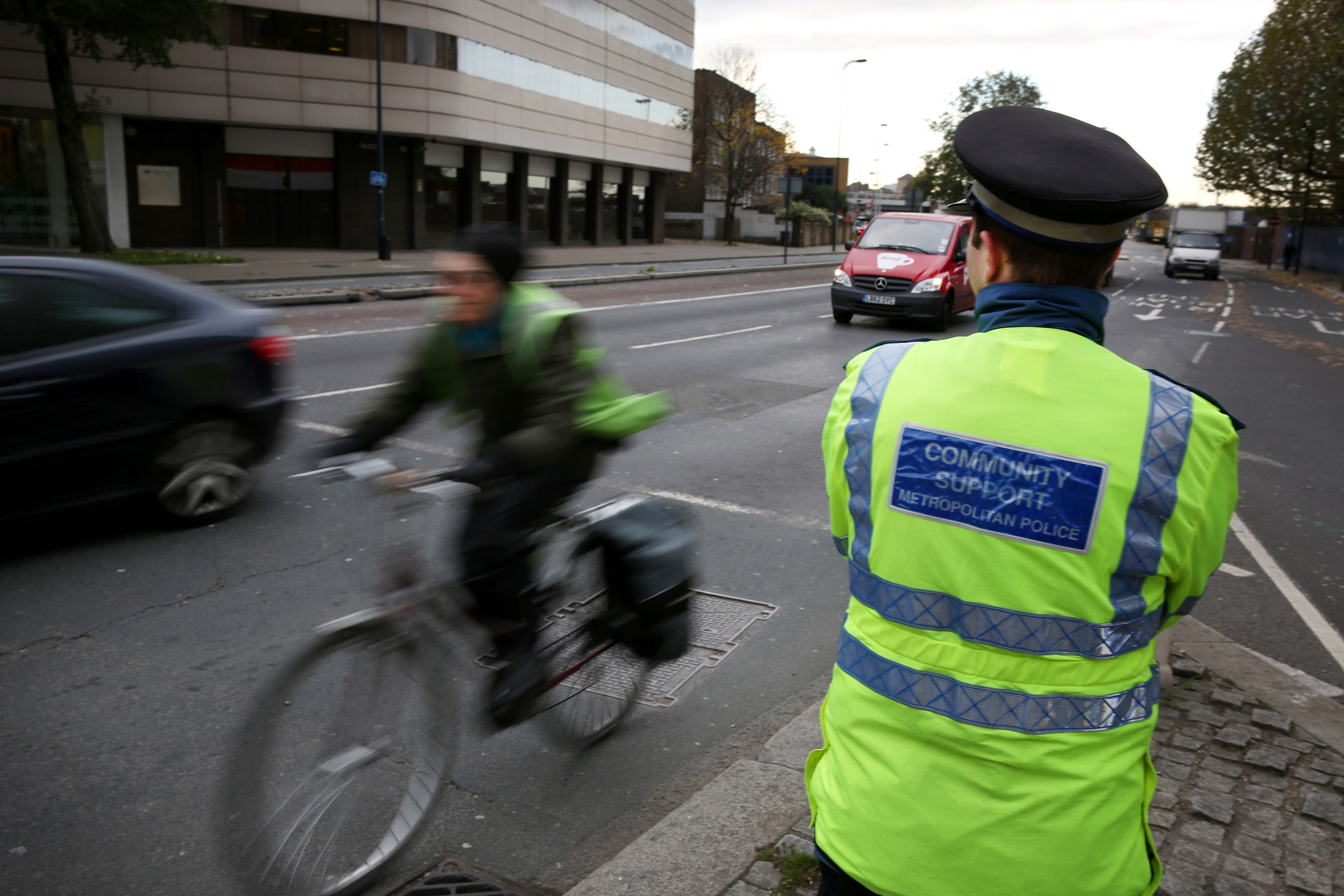 A community support police officer looks out for cyclists