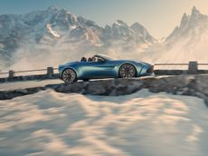 Soft top car driving through a mountain pass