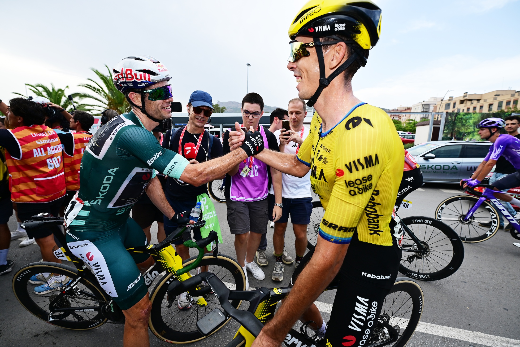Van Aert and Brennan shake hands after the Briton won stage 11