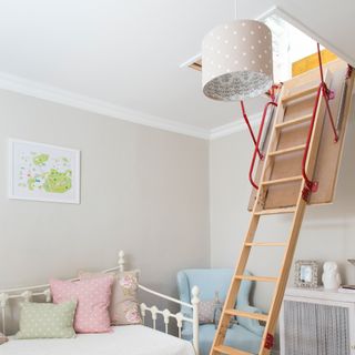 Child's room with ladder leading up to loft space