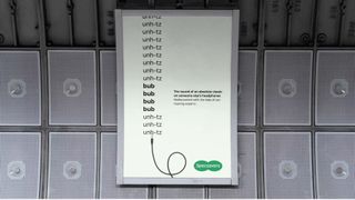 Specsavers billboard featuring text that reads "the sound of an absolute classic on someone else’s headphones"