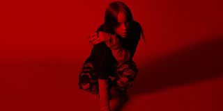No Time To Die Billie Eilish crouching in a red atmosphere