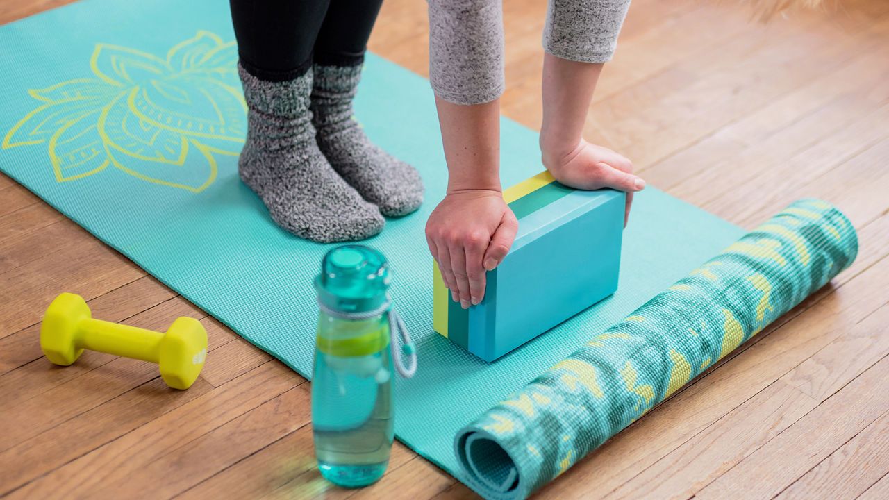 Best yoga blocks: Woman using yoga block as a prop