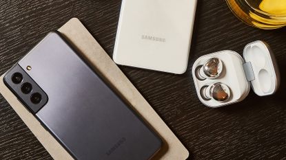Samsung Galaxy phone with earbuds on a table
